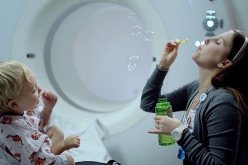 Child life specialist blowing bubbles
