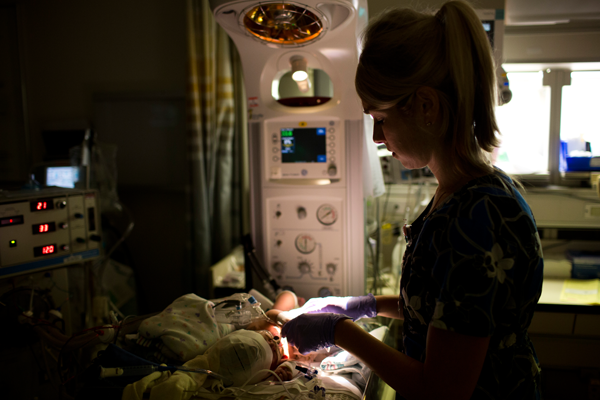 Nurse attending to neurocritical nicu baby
