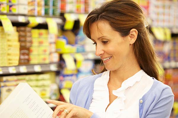 Woman looking at package food labeling