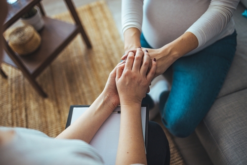 doctor holding patient's hand