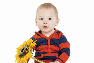 Cute little boy holding a sunflower