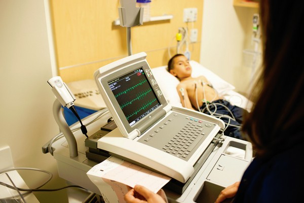 Technician monitoring young boy during test