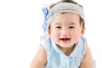 Happy baby girl with headband