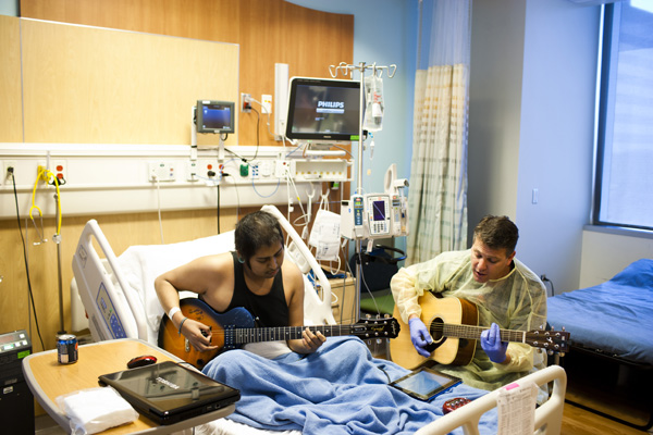 Child life specialist and patient playing guitars