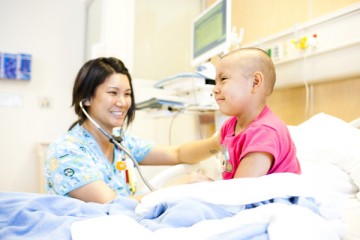 Nurse at bedside of cancer patient