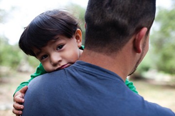 Father carrying his young son