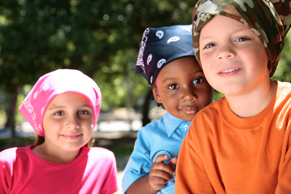 Three young cancer patients wearing scarfs