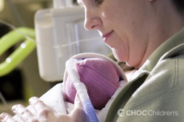 Mother holding her baby in the NICU