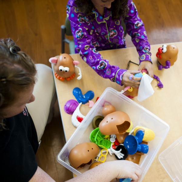 Child life specialist and patient playing with mr potato head