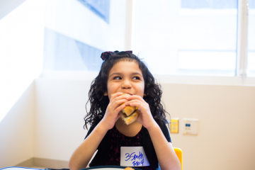 Young girl eating a hamburger