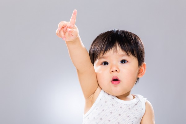 Cute little girl holding up her finger