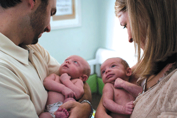 Parents holding newborn twins