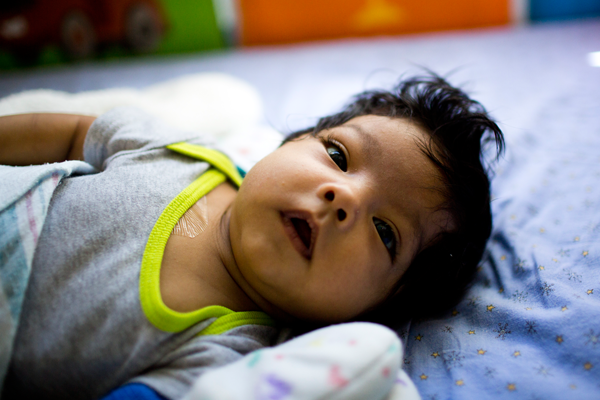 Infant boy in bed