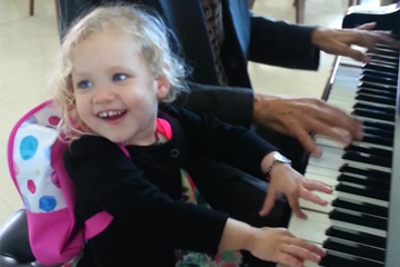 young cochlear implant patient playing the piano