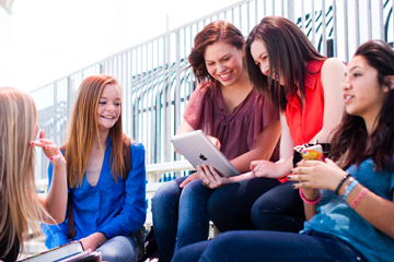 Teens outside on the bleachers at school