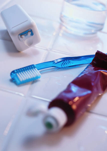 Toothbrush, toothpaste and floss on the counter