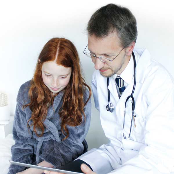Physician showing young girl information on his ipad