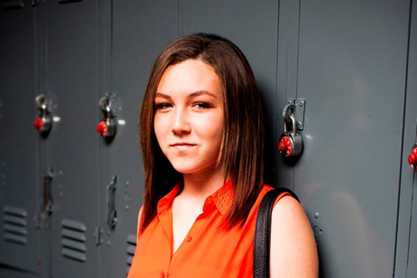 Teen girl in front of school lockers