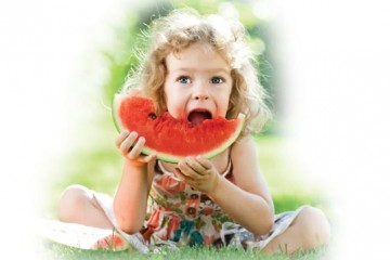 Young girl eating watermelon