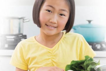 Smiling girl in front of healthy foods