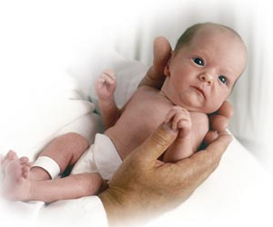 Preemie nestled in adult hands