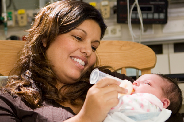 Mom feeding her baby in the NICU