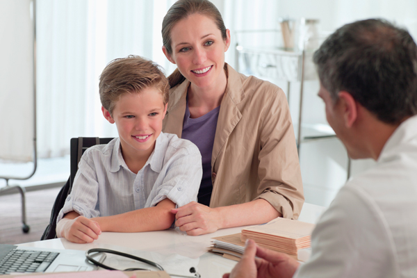 Mom and son at office visit with physician