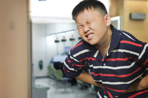 Boy experiencing severe stomachache