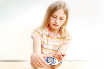 Teen girl giving herself a blood test