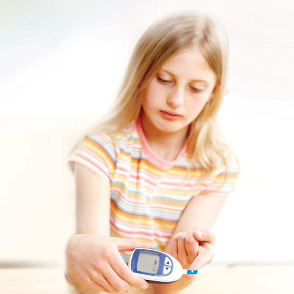 Teen girl giving herself a blood test