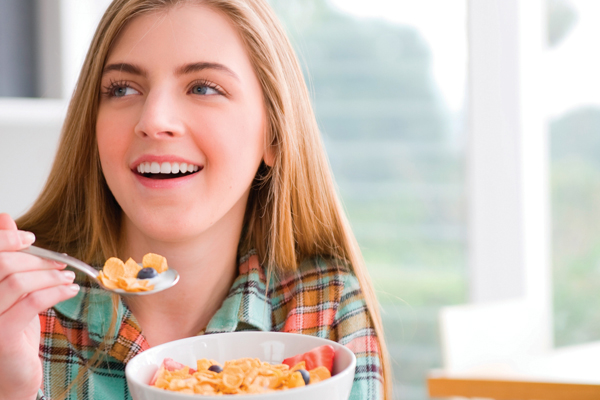 Teen girl eating cereal