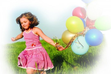 Girl running outside with colorful balloons