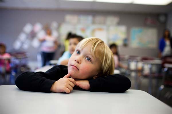 Young boy at desk in classroom