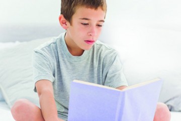 Young boy reading a book