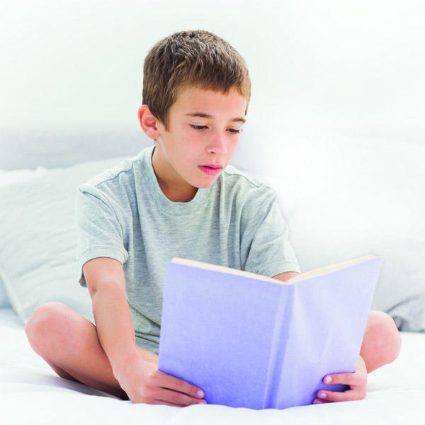 Young boy reading a book