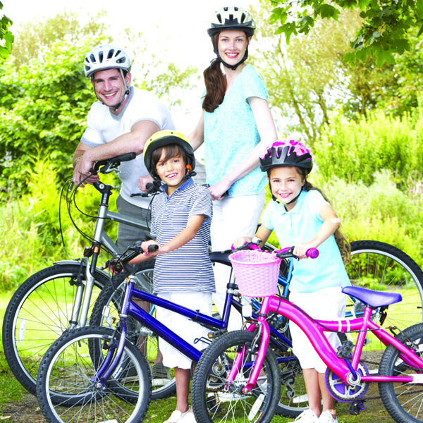 Family on their bikes all wearing helmets