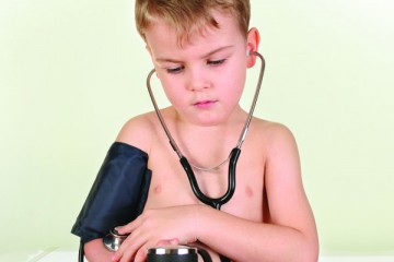 Young boy taking his own blood pressure