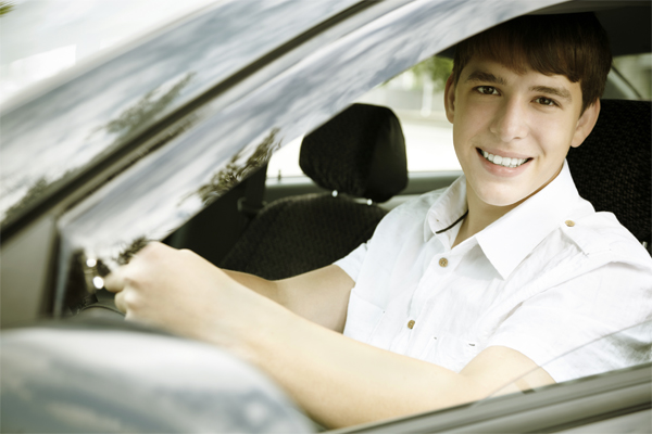 Teens boy in the driver's seat of a car