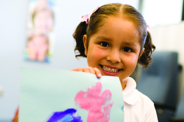 Girl showing her artwork