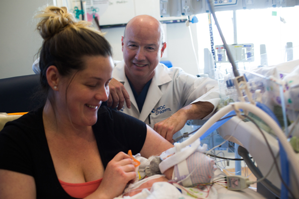 Physician with mom and infant in the CVICU