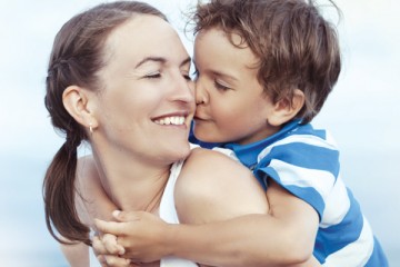 Young son kissing his mom