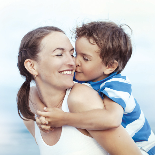 Young son kissing his mom