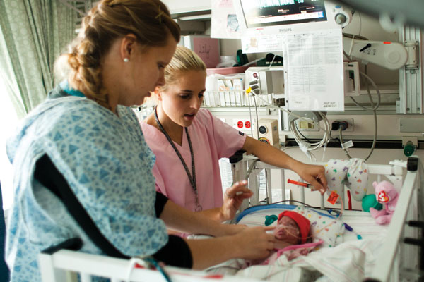 Mom and nurse caring for baby in the CHOC NICU at Mission Hospital