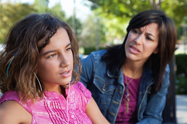 Concerned mom talking with her teenaged daughter