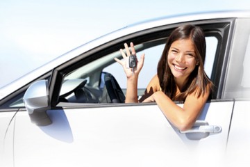 Girl in driver's seat of car holding the car keys