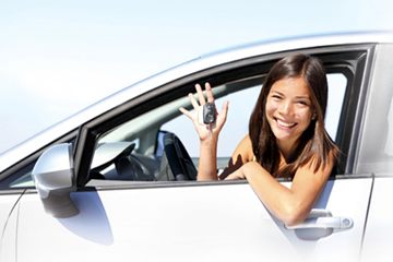 Girl in driver's seat of car holding the car keys