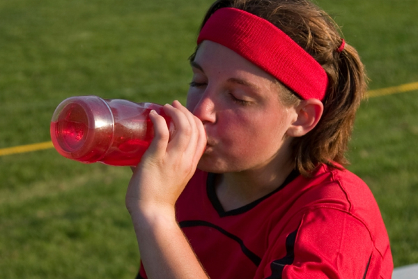 Teen athlete drinking energy drink