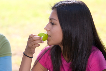 teen girl eating an apple