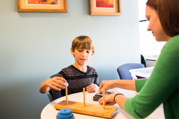 Young boy at therapy session with a pediatric psychologist