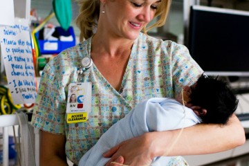 CHOC NICU nurse cradles baby
